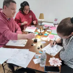 Group of participants practicing calligraphy together