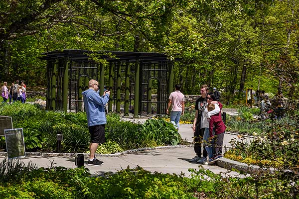 Visitors on a sunny day taking pictures in the Garden of Inspiration